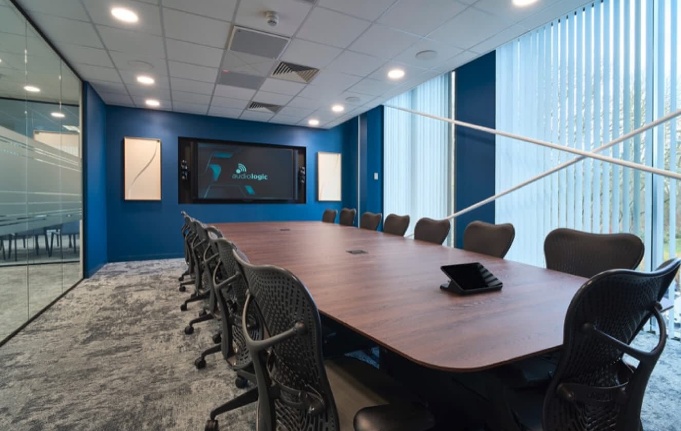Large demonstration room with large screen and large desk